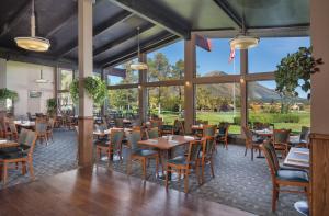 a dining room with tables and chairs and large windows at Flagstaff Resort 2BR Apartment in Flagstaff