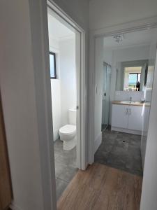 a bathroom with a toilet and a sink at Kingston Foreshore Caravan Park in Kingston South East +81 photos