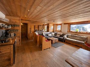 a living room with a couch and chairs in a cabin at Chalet Sandy in Les Gets