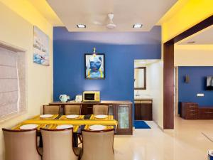 a dining room with a yellow table and chairs at Spellbound in Wadgaon
