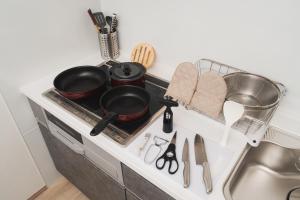 a kitchen stove with pots and pans on it at みたまの湯宿 in Beppu +19 photos