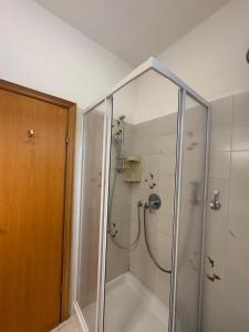 a shower with a glass enclosure in a bathroom at Mare Mio Talamone in Talamone +8 photos