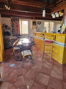 a kitchen with a table and chairs in a room at Mas Saint Jean in Arles