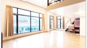 a large living room with a large window with a view at Gapyeong Dolgorae Resort in Gapyeong