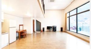 an empty kitchen and living room with a large window at Gapyeong Dolgorae Resort in Gapyeong