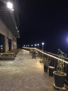 a row of tables and benches in a building at night at Gapyeong Dolgorae Resort in Gapyeong