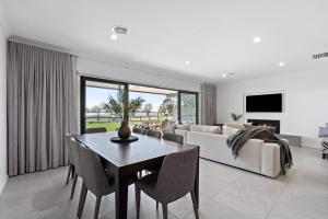 a living room with a table and a couch at Marine Cove in Yarrawonga