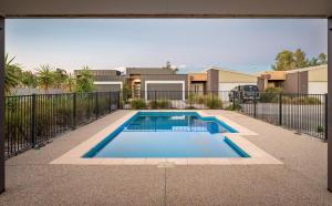 a swimming pool in front of a house at Marine Cove in Yarrawonga