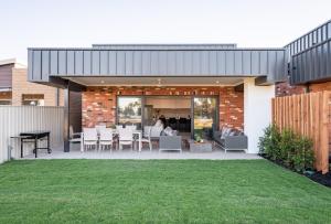 a house with a patio and a lawn at Marine Cove in Yarrawonga