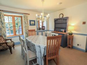 a dining room with a table and chairs at Rose Cottage Coniston in Coniston