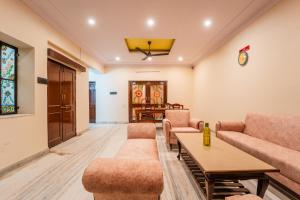 a living room with couches and a table at The Amber House - Luxury Boutique Stay in Bani Park, City Center Jaipur in Jaipur