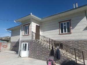 a house with a brick staircase with a pink backpack at Archa in Osh