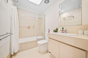 a bathroom with a toilet and a shower and a sink at Fairway Retreat in The Vines +49 photos