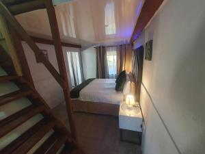 a small bedroom with a bed with a candle on a table at Blu light lodge in Randfontein +5 photos