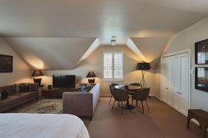 a room with a bed and a couch and a table at Briarwood in Greytown