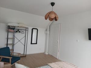 a bedroom with a bed and a room with a ladder at Les mouettes in Huisnes-sur-Mer