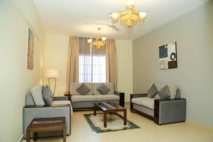 a living room with a couch and a table at Samaraham Residency in Indāf
