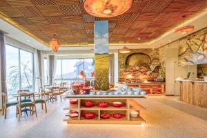 a restaurant with a table with red bowls on it at Olive Hotel Da Lat in Da Lat