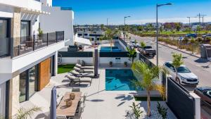 an apartment patio with a pool and a parking lot at Villa Don Grosa - Luxury Family Retreat in Torre-Pacheco