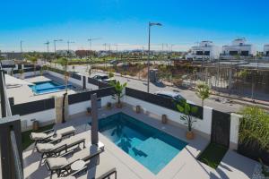 a balcony with a swimming pool on top of a building at Villa Don Grosa - Luxury Family Retreat in Torre-Pacheco