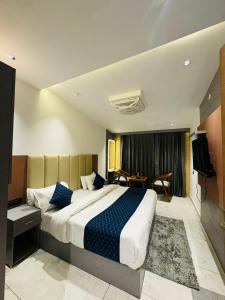 a hotel room with a large bed and a television at The Moonsoon Inn in Mussoorie +14 photos