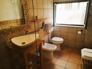 a bathroom with a sink and a toilet and a window at Il Giardino Dei Sospiri in Ragusa +46 photos