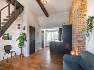 a living room with a blue couch and a brick wall at Two-bedroom apartment by the river in Antwerp