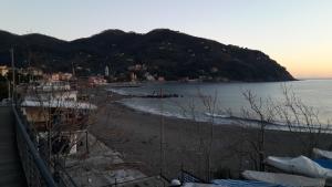 a view of a beach with a mountain in the background at Sportrek House in Levanto +3 photos