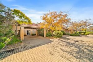 a large house with a driveway in front of it at Fairway Retreat in The Vines