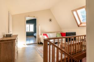 a living room with a staircase and a couch at Steinbockblick Maienfeld in Maienfeld