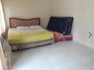 a small room with a bed and a suitcase at Villa Venesia Berastagi Resort in Berastagi