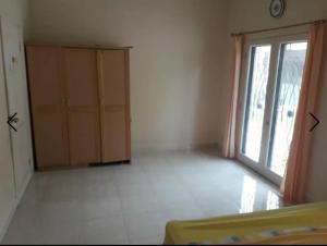 an empty room with a large window and a door at Villa Venesia Berastagi Resort in Berastagi +3 photos