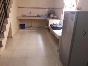 a small kitchen with a sink and a refrigerator at Villa Venesia Berastagi Resort in Berastagi