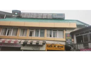 a building with a sign on top of it at The Moonsoon Inn in Mussoorie