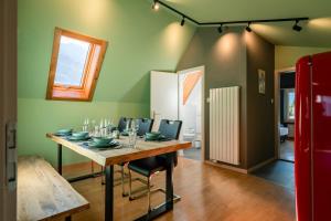a dining room with a table and chairs at Steinbockblick Maienfeld in Maienfeld