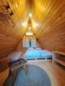 a room with a bed in a wooden cabin at PUŽMAN Farm Glamping in Radovljica