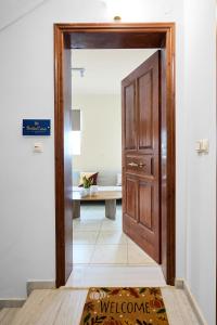 a door leading into a room with a table at Bella Casa Chios in Chios +11 photos