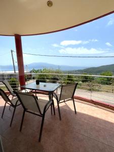 a table and chairs on a balcony with a view at Up on the hill in Nafpaktos +35 photos