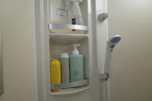 a refrigerator door with hygiene products in it at カルフールゲストハウス別館 in Toyama +23 photos