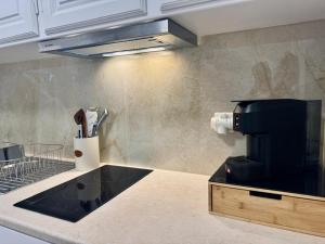 a kitchen with a coffee maker on a counter at Aktea Apartments II in Kefalos