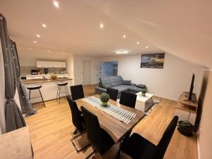 a living room with a table and a couch at Toukam's Apartment, near Ingolstadt in Stammham