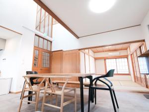 a dining room with a table and chairs at rinne 伊豆 Private Spa in Ito
