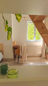 a living room with a table and a window at L'orée du vignoble in Vaux-en-Beaujolais