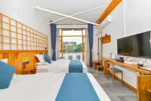 a hotel room with a bed and a tv at Guilin Changshe Hotel in Guilin