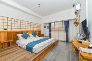a bedroom with a large bed and a desk at Guilin Changshe Hotel in Guilin