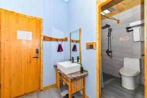a bathroom with a sink and a toilet at Guilin Changshe Hotel in Guilin +72 photos