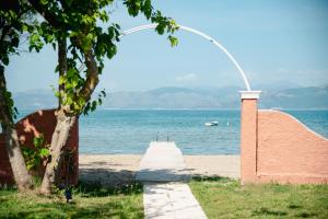 a walkway leading to the water with a building at Melador beachfront studios in Kavos