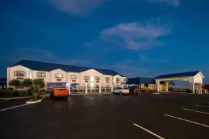 a building with a parking lot in front of it at Days Inn by Wyndham Troy in Troy