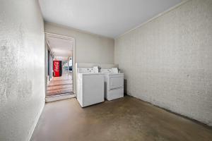 a laundry room with a washer and dryer in it at Days Inn by Wyndham Troy in Troy