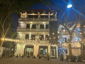 a large white building with christmas lights on it at Polhena Neptune Resort in Matara